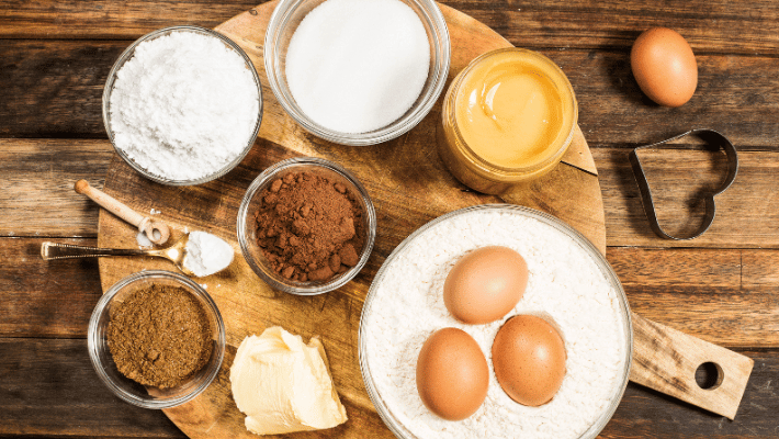 How to Make Homemade Probiotics for Dogs- A close-up of eggs surrounded by various spices including paprika and parsley on a wooden surface that will be used for home-made probiotics 